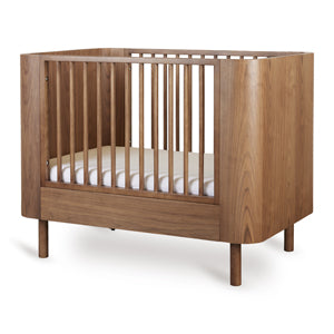 Yume Bed 110 × 70 cm – Mitwachsendes Bett aus Eschenholz – Quax: Babybett schräg von vorne.