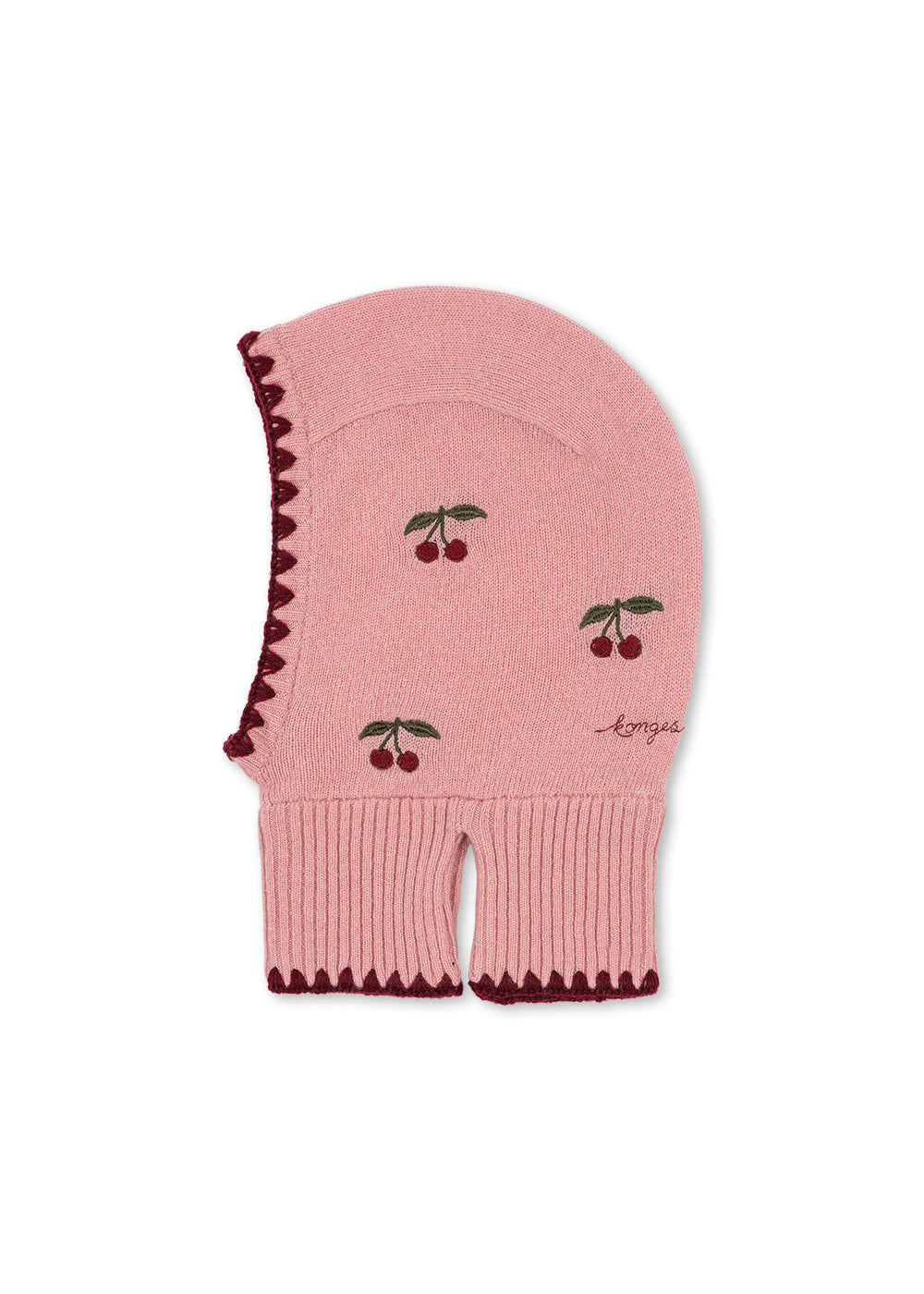 Wollen balaclava Collette – Pale Blush – Konges Sløjd: roze gebreide balaclava met kersen en donkere rand, van opzij.